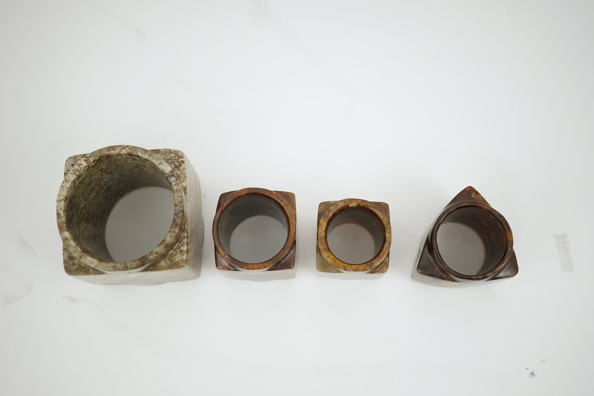 Four Chinese archaistic jade or hardstone cong